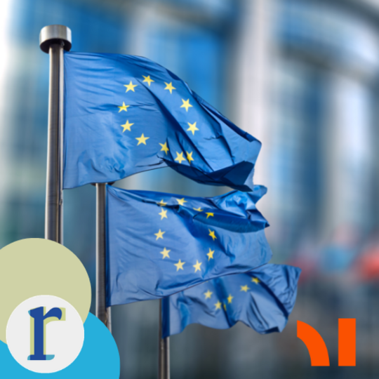 Tree EU flags on poles flying against a blurred glass office-building backdrop.