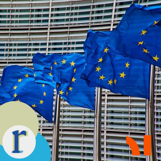 Several EU flags flying on poles in front of a glass office-building facade.