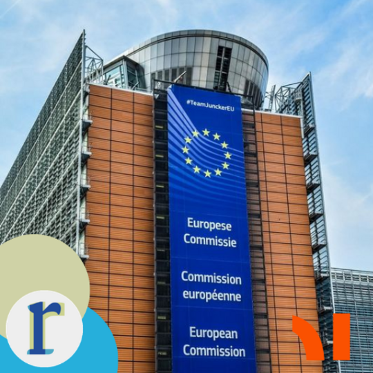 The Berlaymont building, headquarters of the European Commission in Brussels, with a banner on its facade reading "European Commission" in several EU languages.